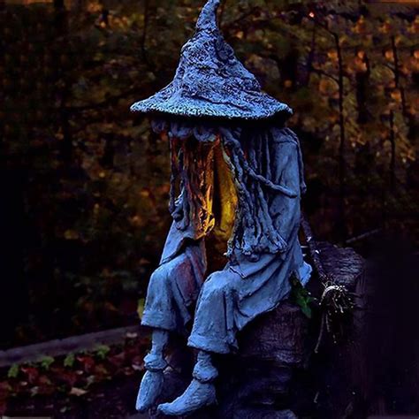 Halloween witch figurine colliding with a tree decoration